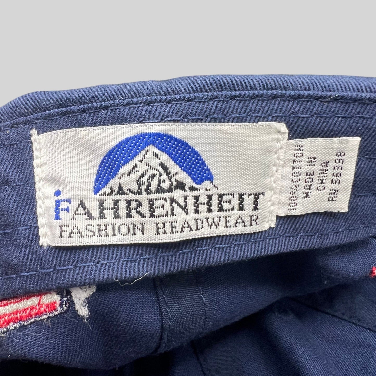 Raree Finds Fahrenheit Fashion Headwear interior brand label on a navy blue cotton strapback hat