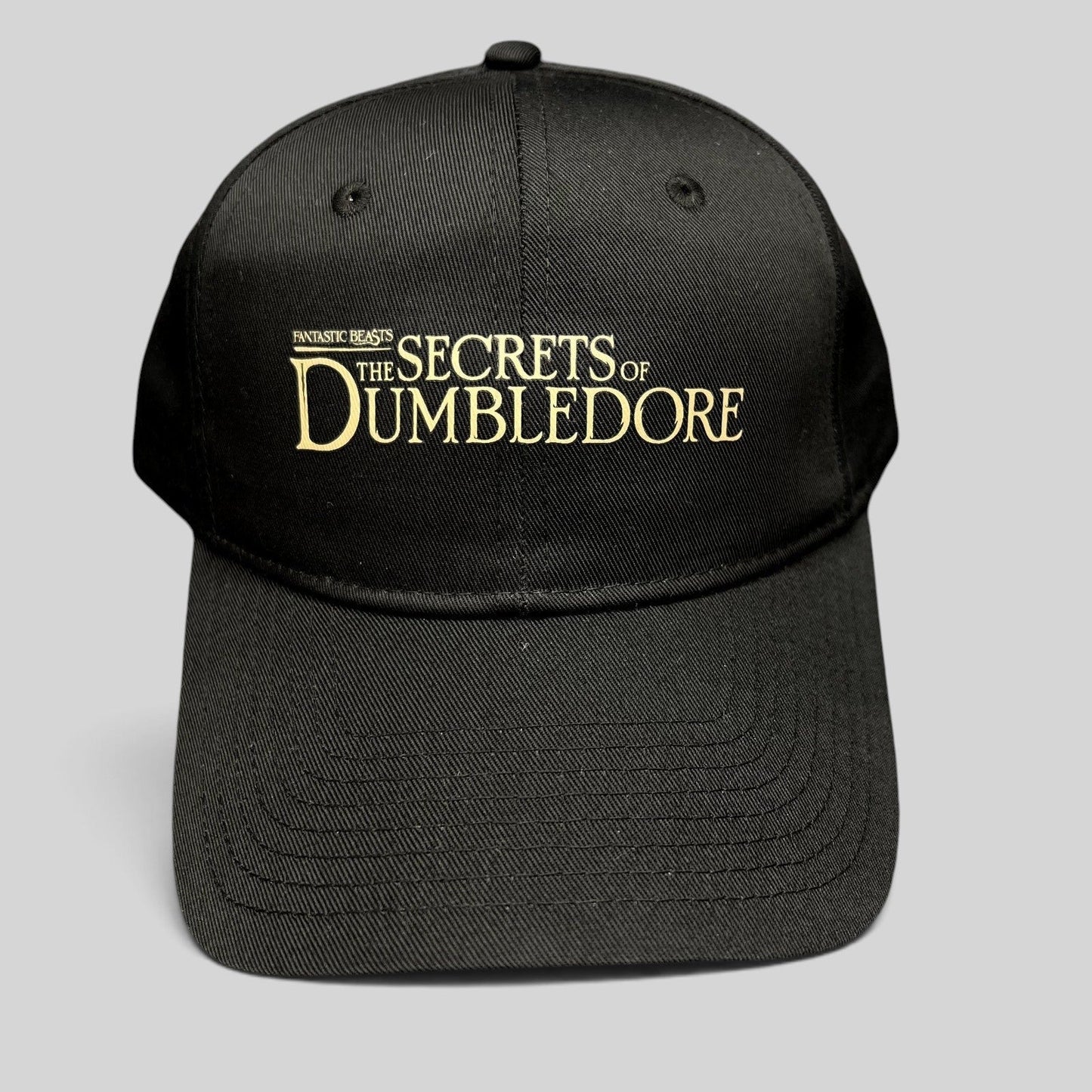 Raree Finds black snapback hat featuring gold embroidered Fantastic Beasts The Secrets of Dumbledore movie logo
