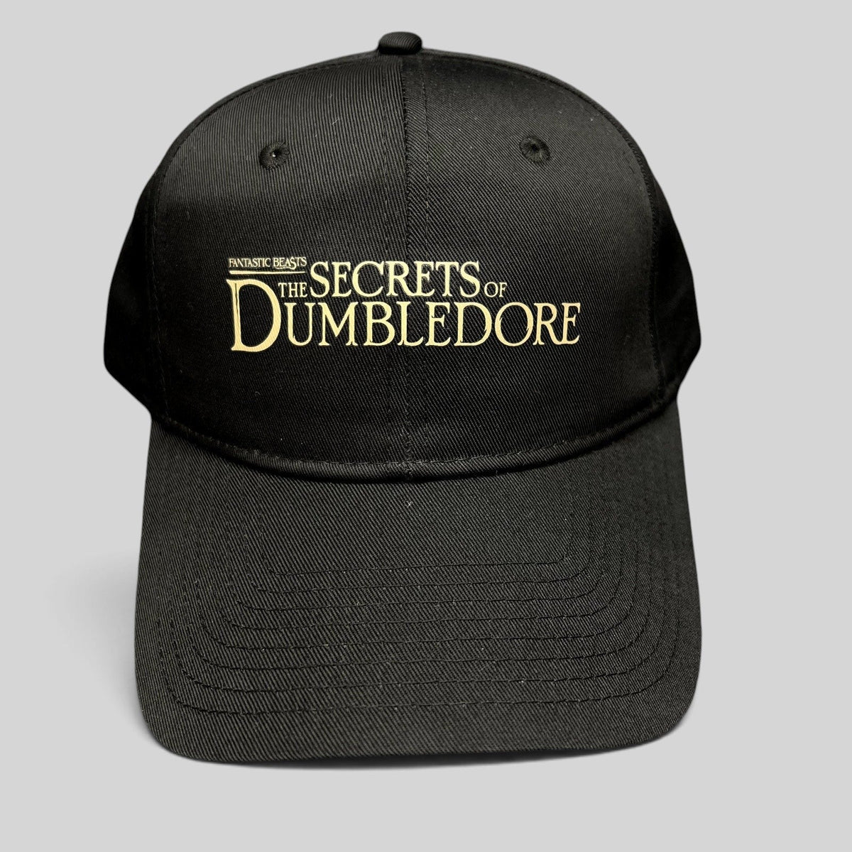 Raree Finds black snapback hat featuring gold embroidered Fantastic Beasts The Secrets of Dumbledore movie logo