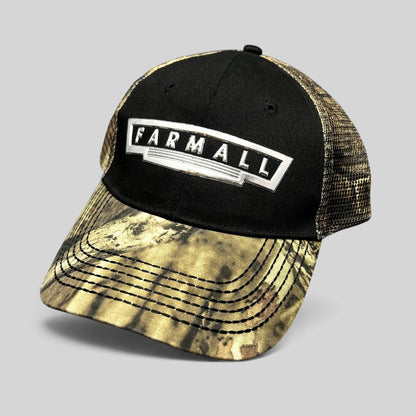 Raree Finds Farmall trucker hat with black cotton crown, camouflage brim, mesh back, and metallic logo patch.