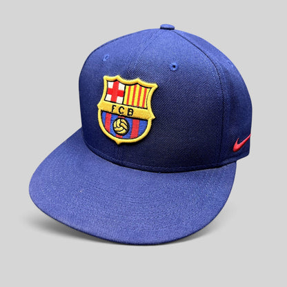Raree Finds navy blue FC Barcelona snapback hat with embroidered FCB crest and red Nike Swoosh on the side.