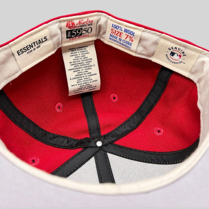 Interior view of Raree Finds Fear of God Essentials x New Era 59FIFTY wool fitted hat showing branding and size tags.