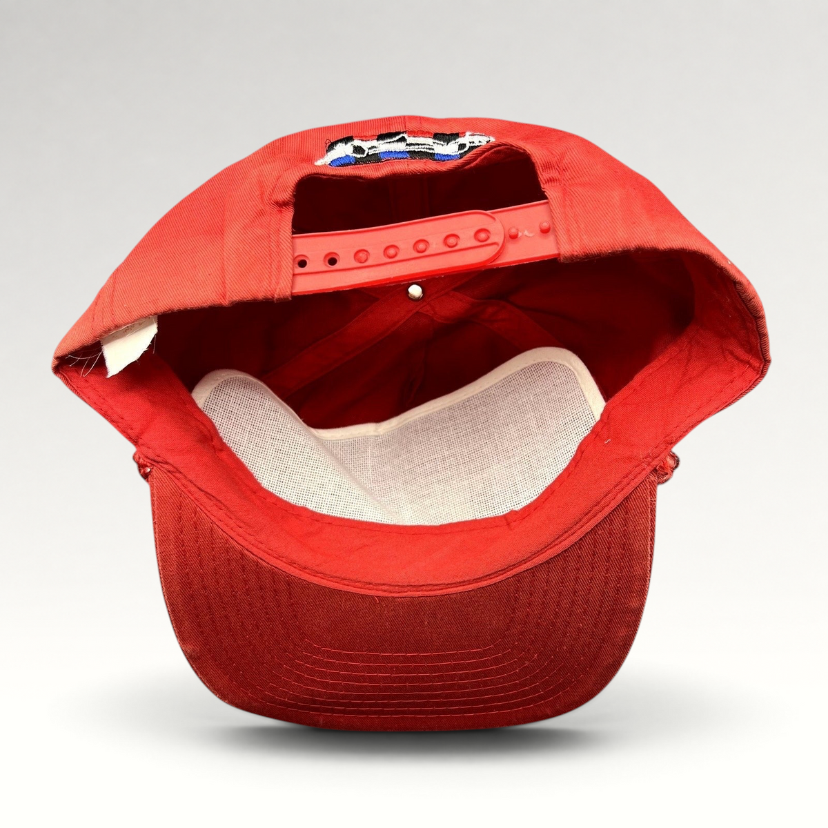 Raree Finds vintage Firestone Racing red snapback hat showing the interior adjustable strap and white mesh lining