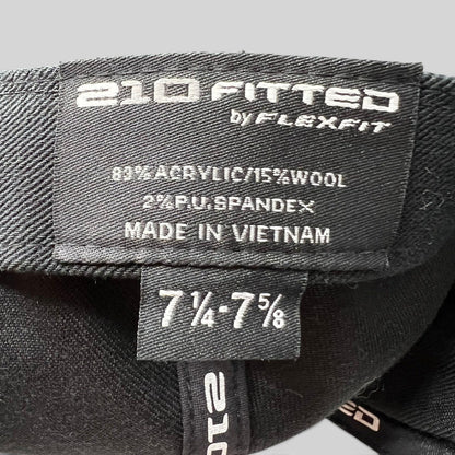 Raree Finds black Flexfit 210 fitted hat interior label showing size 7 1/4 to 7 5/8 and material composition