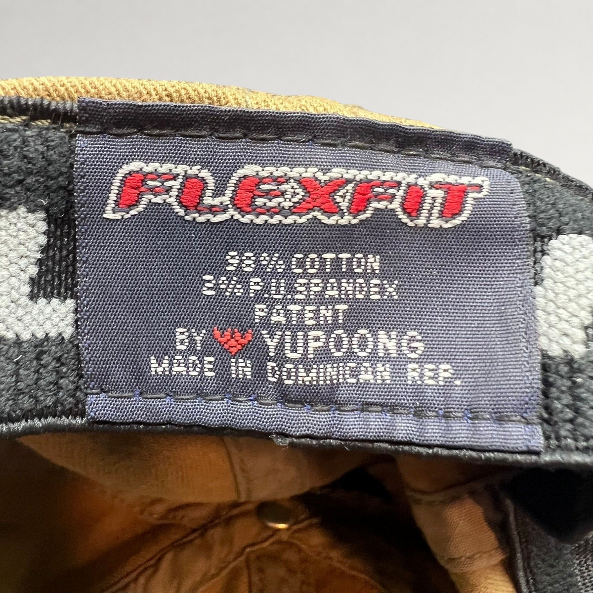 Raree Finds Flexfit hat interior label showing cotton spandex material composition and Yupoong manufacturing details