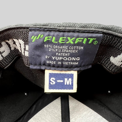 Raree Finds black Yupoong Flexfit hat interior label showing size S-M and material composition