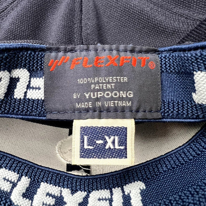 Raree Finds navy blue Flexfit by Yupoong hat interior label showing size L/XL and polyester material details