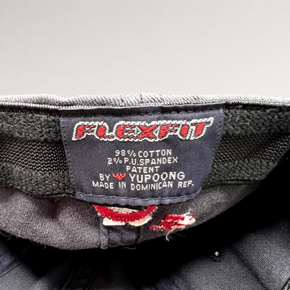 Raree Finds vintage Flexfit hat interior tag showing Yupoong branding, material composition, and origin details.