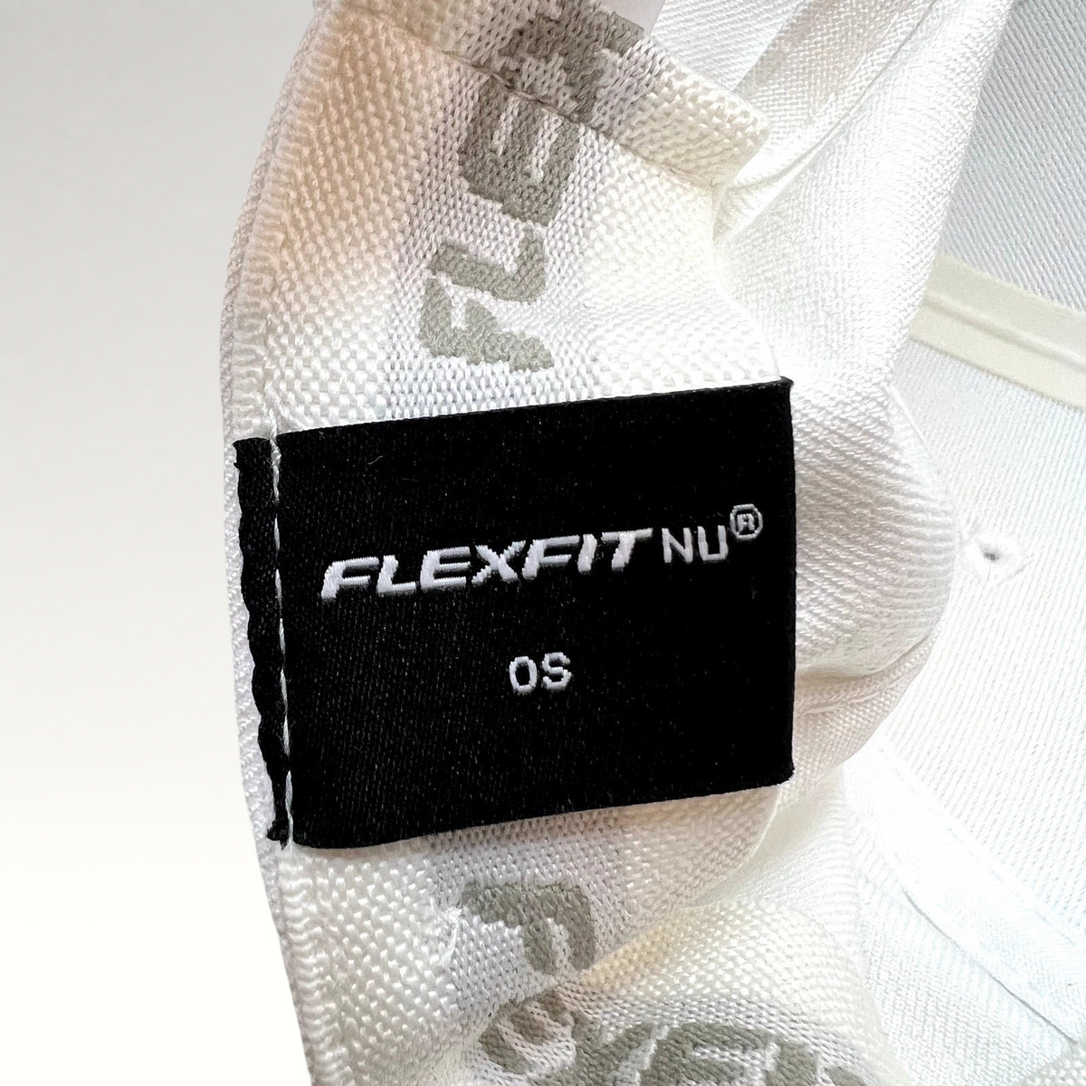 Raree Finds white Flexfit NU hat interior label showing size OS and branding on the inner seam tape
