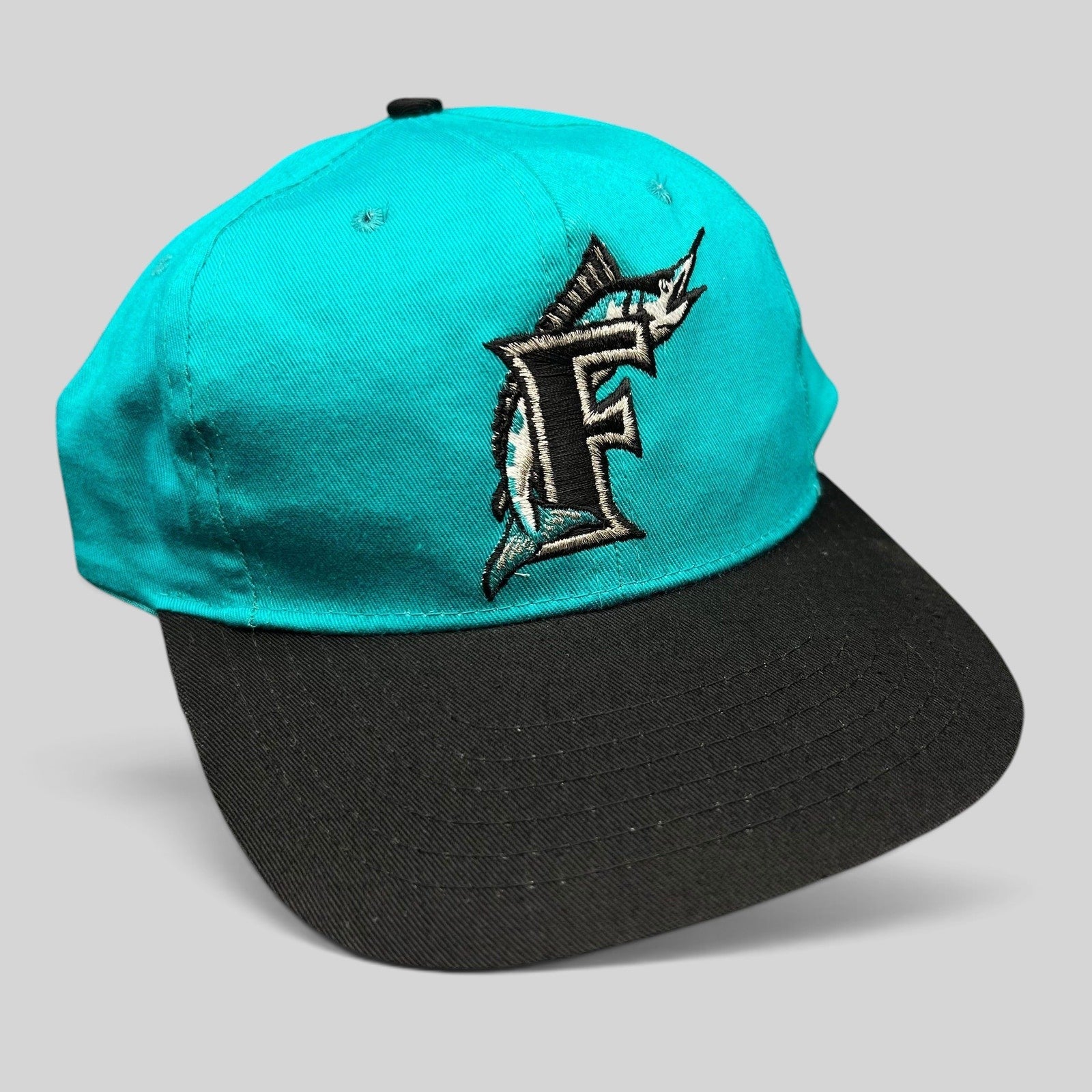 Raree Finds vintage Florida Marlins youth snapback cap with teal crown, black brim, and embroidered marlin F logo.