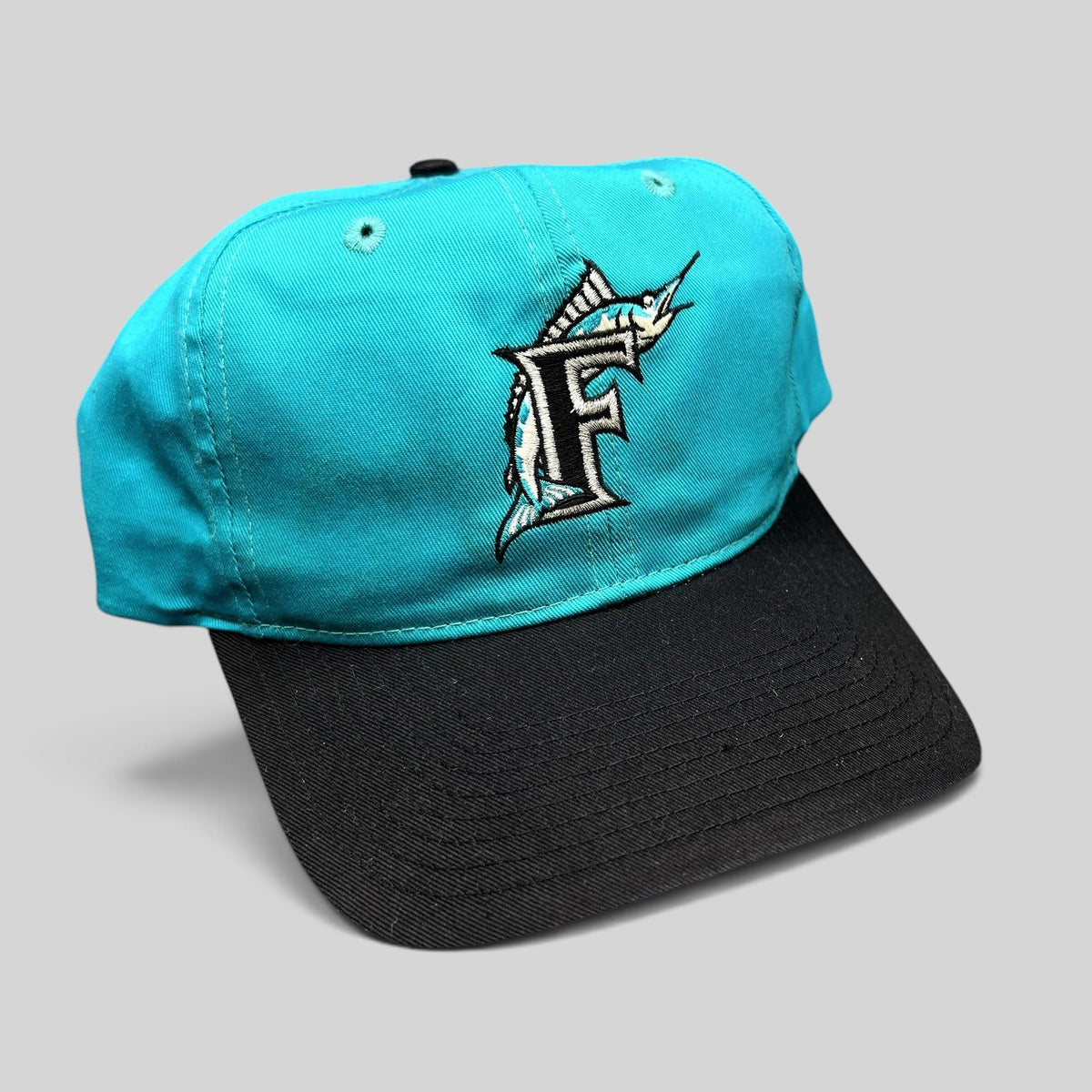 Raree Finds vintage Florida Marlins snapback hat with a teal crown, black brim, and embroidered F logo.