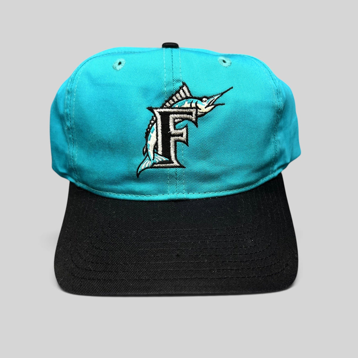 Raree Finds vintage Florida Marlins snapback hat featuring a teal crown, black brim, and embroidered F logo.