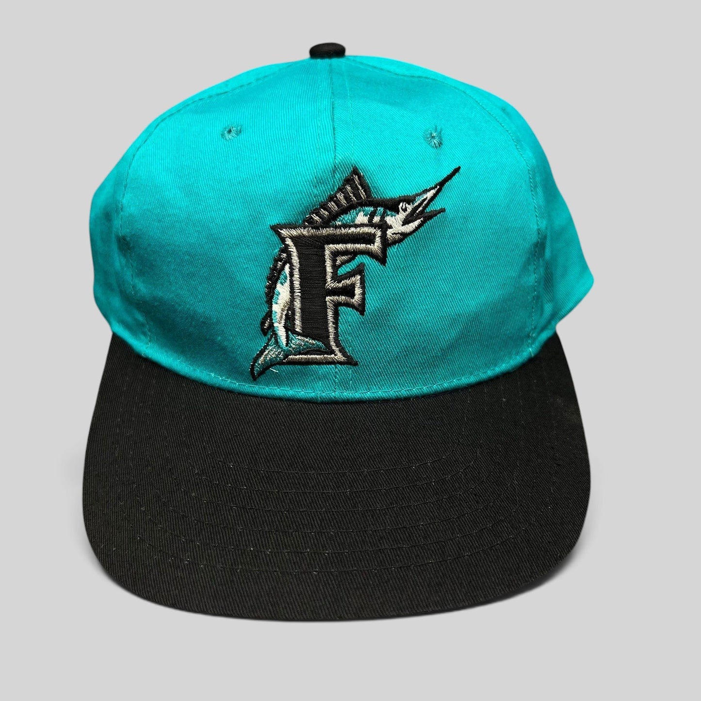 Raree Finds vintage Florida Marlins youth snapback cap with teal crown, black brim, and embroidered marlin F logo.