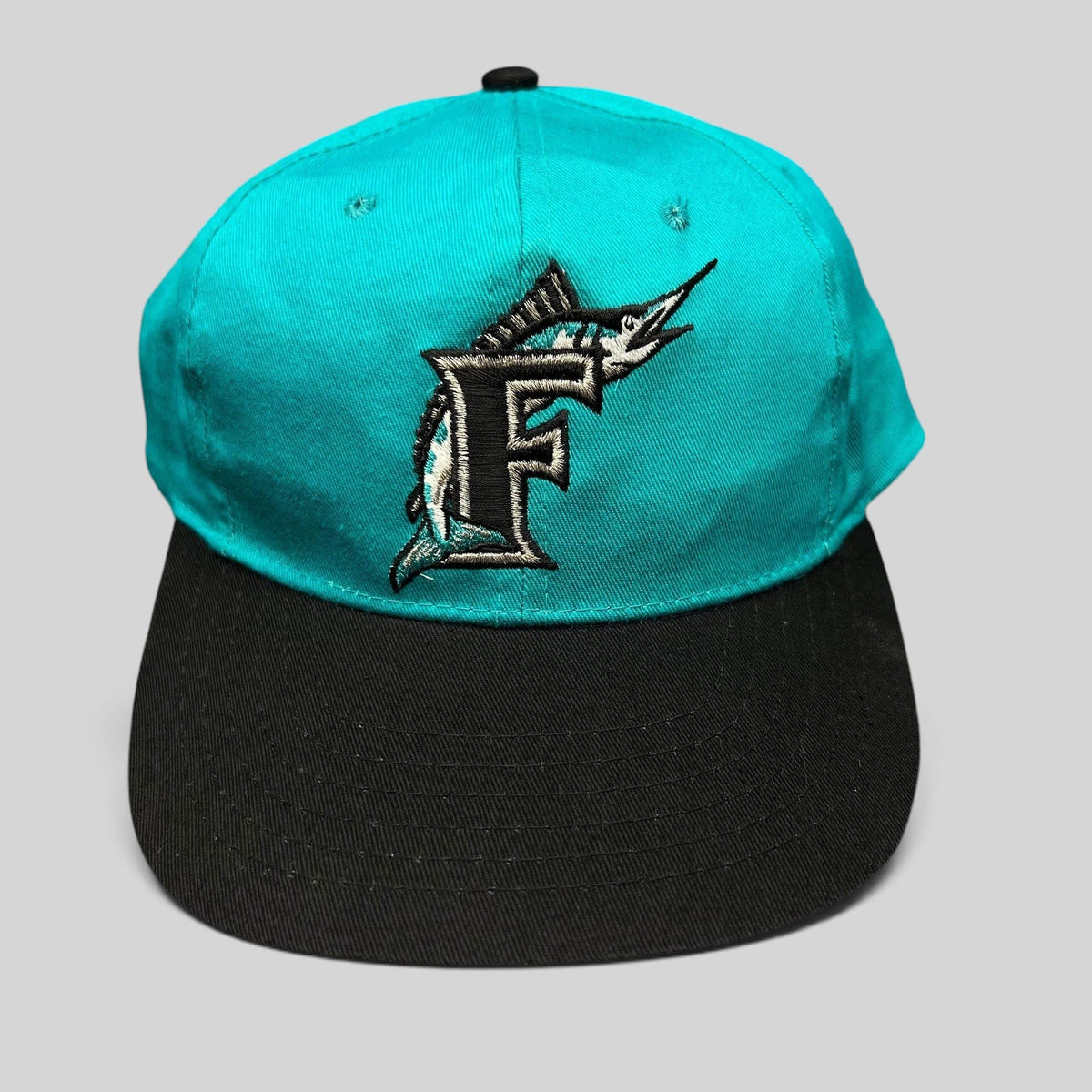 Raree Finds vintage Florida Marlins youth snapback cap with teal crown, black brim, and embroidered marlin F logo.