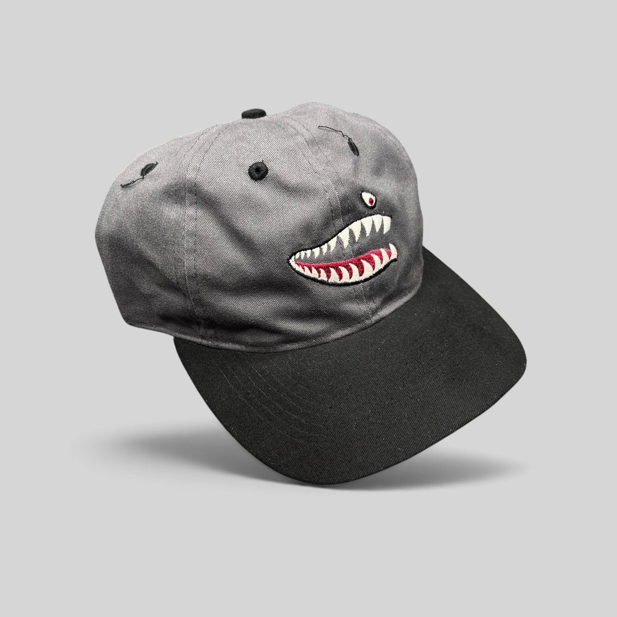 Raree Finds vintage Otto Cap snapback featuring embroidered P-40 Warhawk shark mouth art on a gray and black hat.