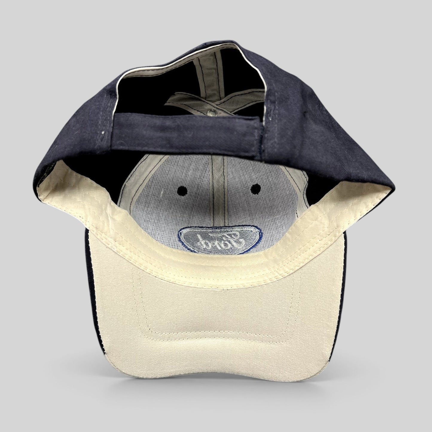 Raree Finds navy and cream Cap America Ford strapback hat showing the interior construction and embroidered logo