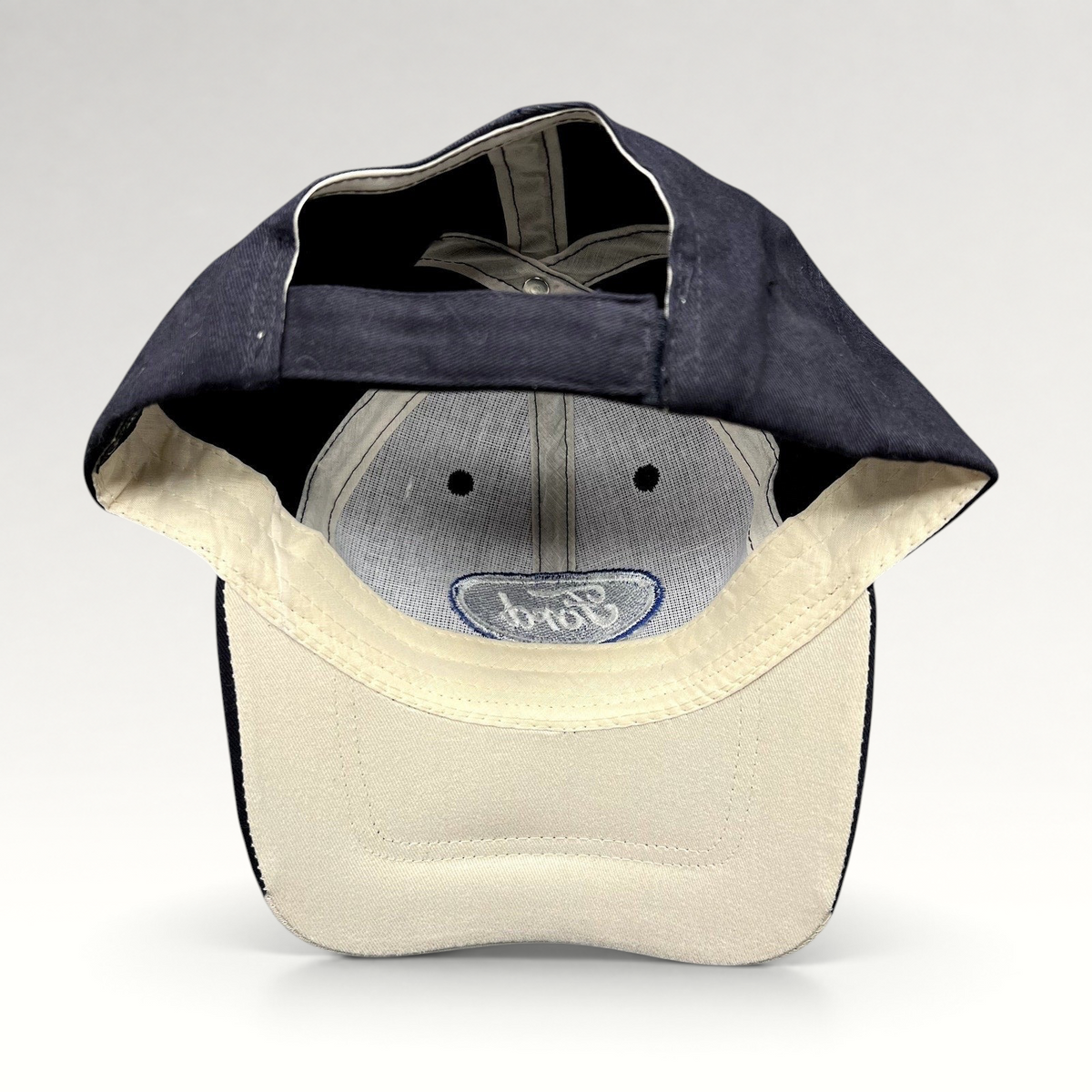 Raree Finds navy and cream Cap America Ford strapback hat showing the interior construction and embroidered logo