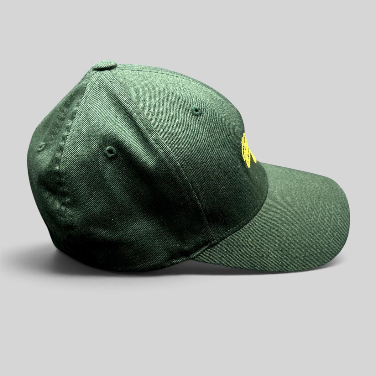 Raree Finds forest green Hanalei Canoe Club Flexfit hat with gold embroidered logo, side profile view.