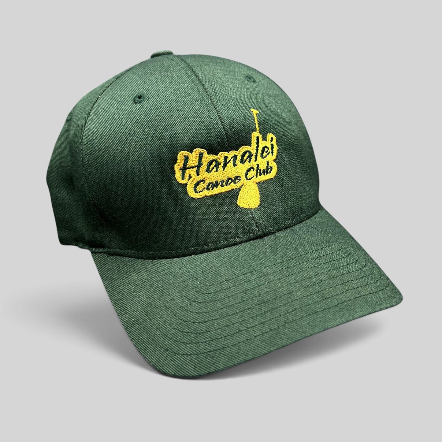 Raree Finds forest green Hanalei Canoe Club Flexfit hat with gold embroidered paddle logo on the front