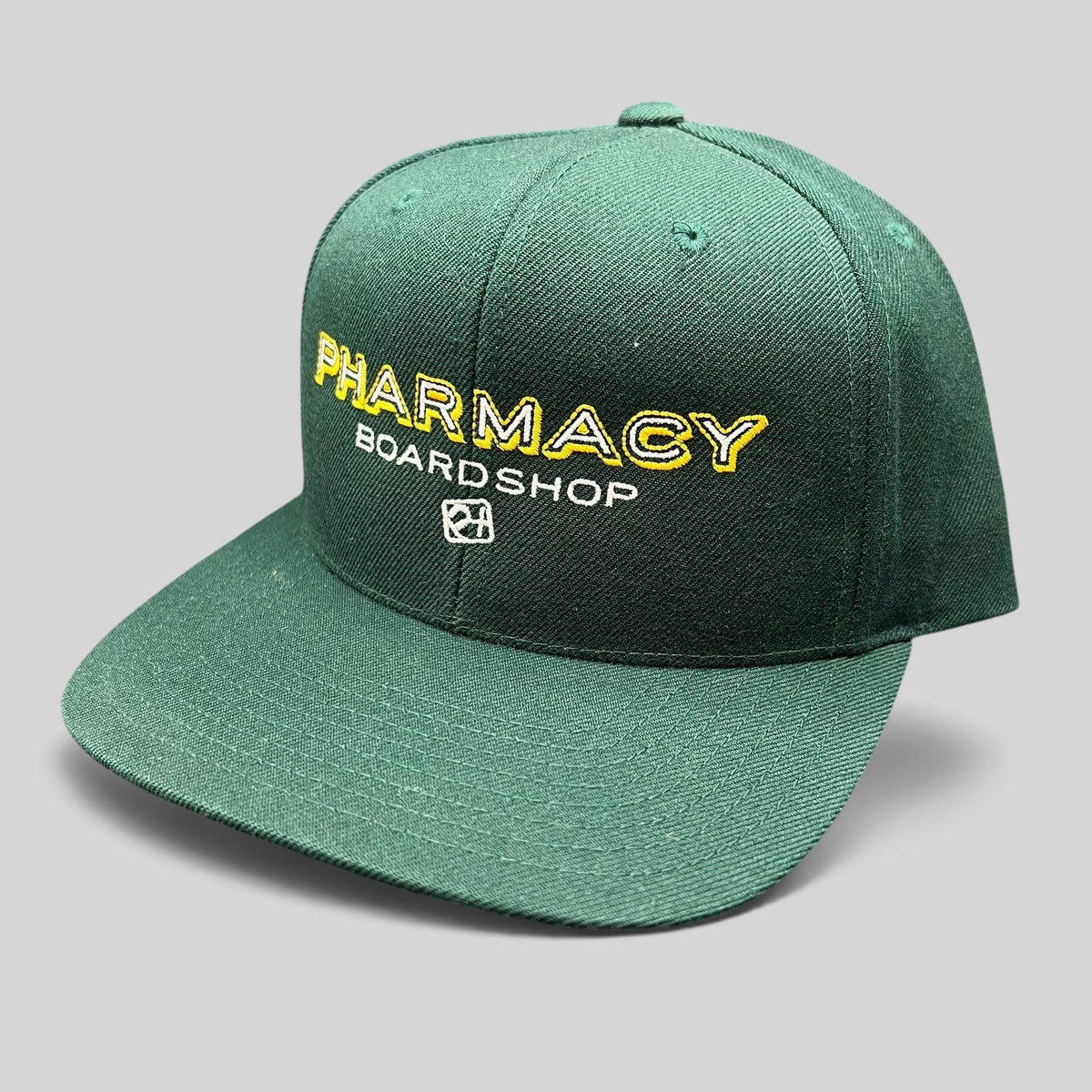 Raree Finds vintage forest green Pharmacy Boardshop snapback hat with yellow and white embroidered skate branding.