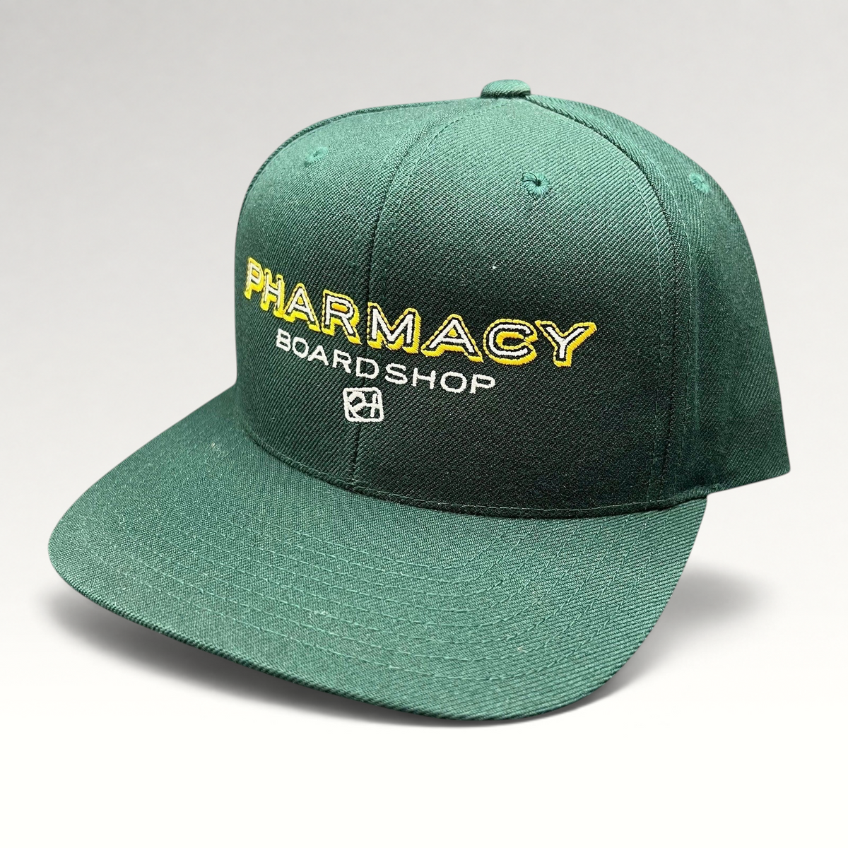 Raree Finds vintage forest green Pharmacy Boardshop snapback hat with yellow and white embroidered skate branding.