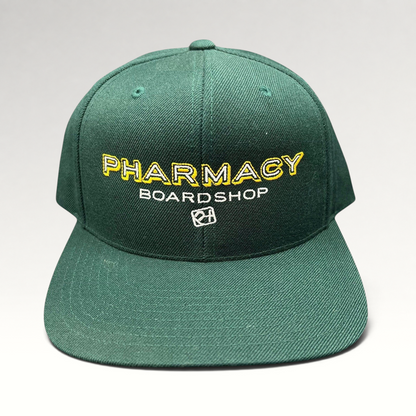 Raree Finds vintage forest green Pharmacy Boardshop snapback hat with yellow and white embroidered skate branding