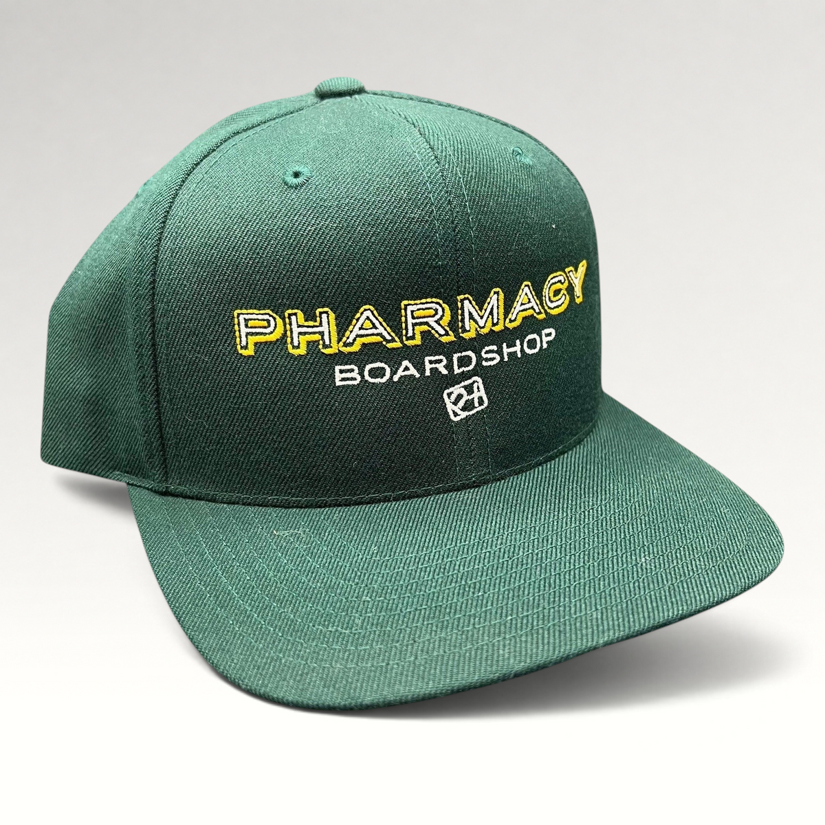 Raree Finds vintage forest green Pharmacy Boardshop snapback hat with yellow and white embroidery on a flat bill cap.