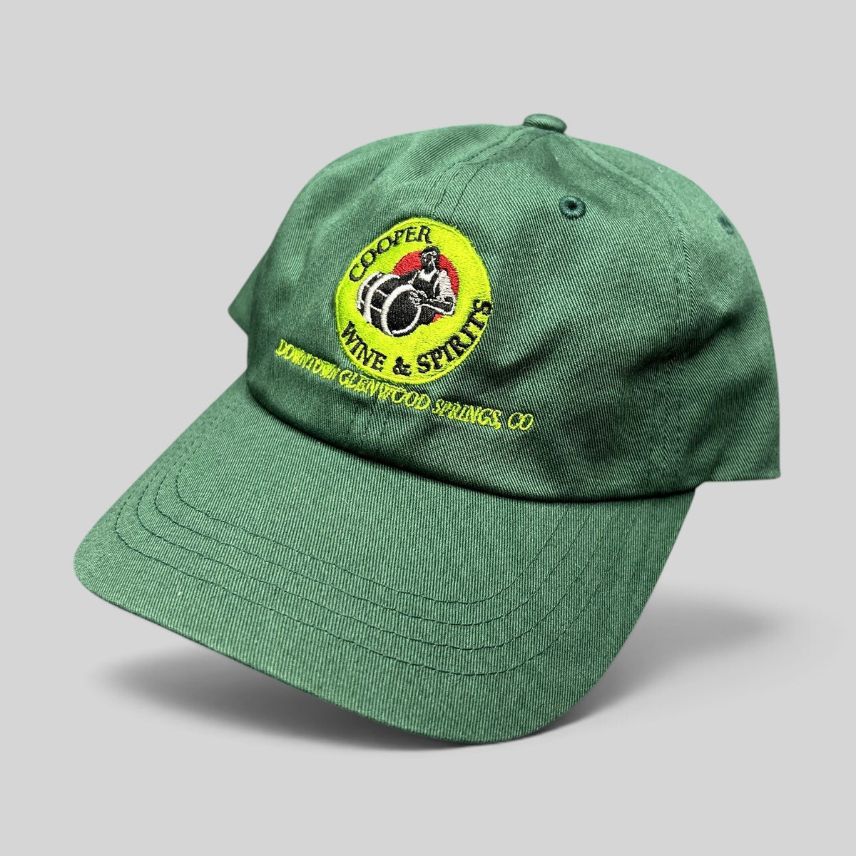 Raree Finds forest green cotton strapback hat with embroidered Cooper Wine & Spirits logo and Glenwood Springs text.
