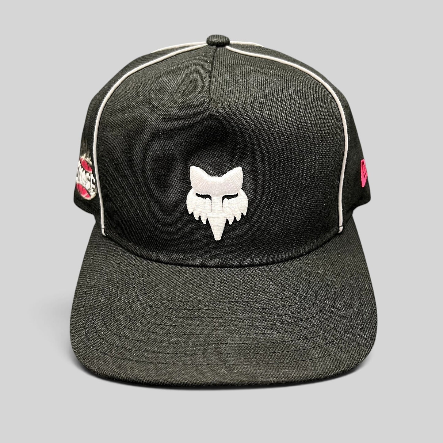 Raree Finds Fox Racing New Era Cosmo black snapback hat with white embroidered fox logo and pink side accents.