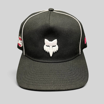 Raree Finds Fox Racing New Era Cosmo black snapback hat with white embroidered fox logo and pink side accents.