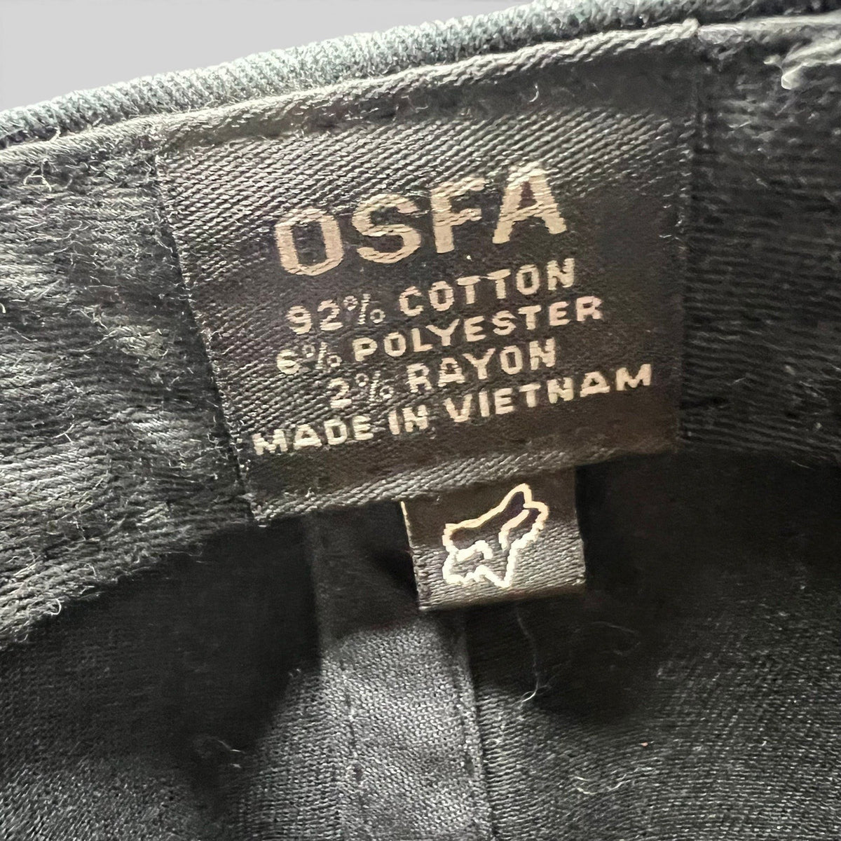 Raree Finds Fox Racing snapback hat interior tag showing OSFA sizing, material blend, and origin details.