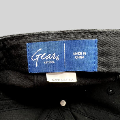 Raree Finds Gear brand blue interior label on a black cotton twill Kalamazoo College strapback dad cap
