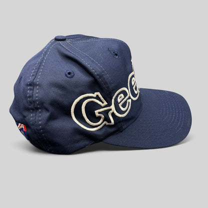 Raree Finds vintage navy blue Geelong AFL snapback hat with white embroidered spellout logo and green undervisor.