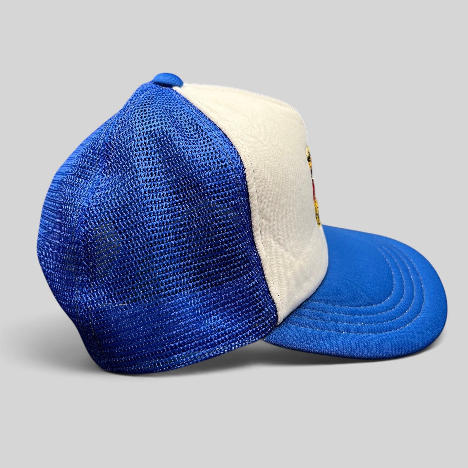 Raree Finds vintage Germany trucker hat with white foam front, royal blue mesh back, and embroidered eagle crest patch