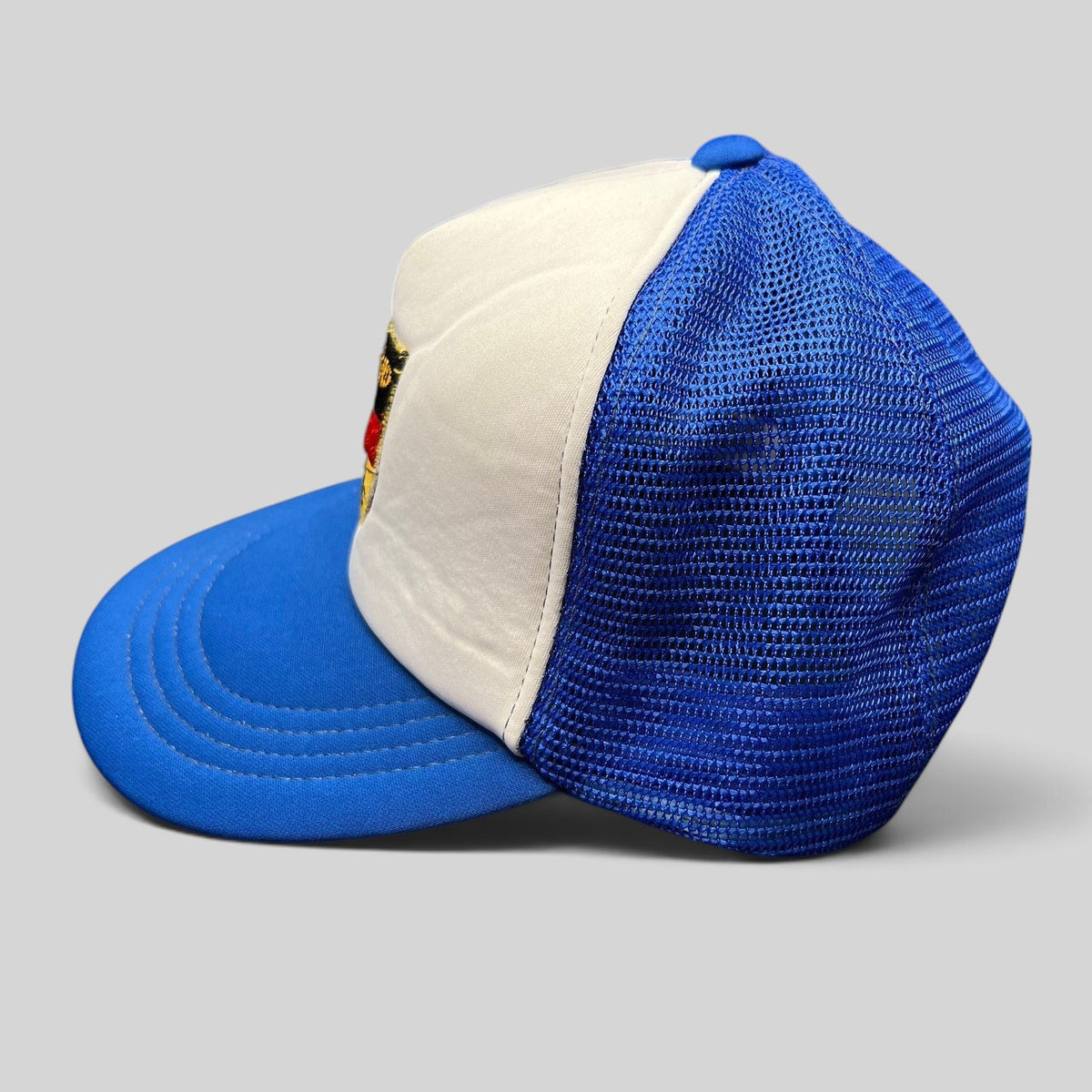 Raree Finds vintage Germany trucker hat with white foam front, royal blue mesh back, and German eagle crest patch.