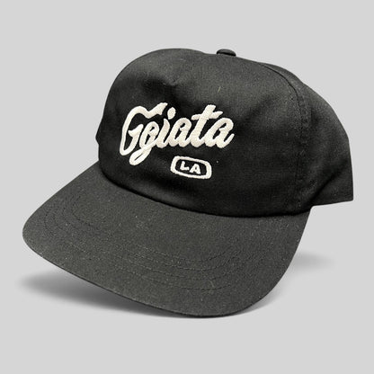 Raree Finds black Ggiata LA snapback hat with white embroidered script logo and flat brim on a structured crown