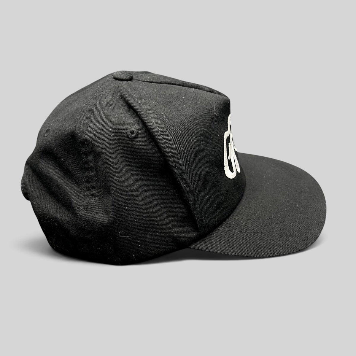 Raree Finds Ggiata LA black snapback hat with white embroidered script logo and flat brim on a structured crown