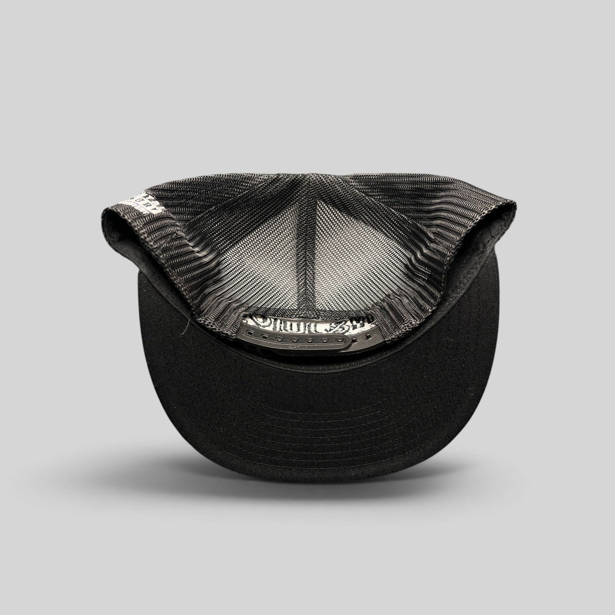 Raree Finds Gin & Juice snapback hat showing the interior mesh lining, structured crown, and adjustable snap closure.