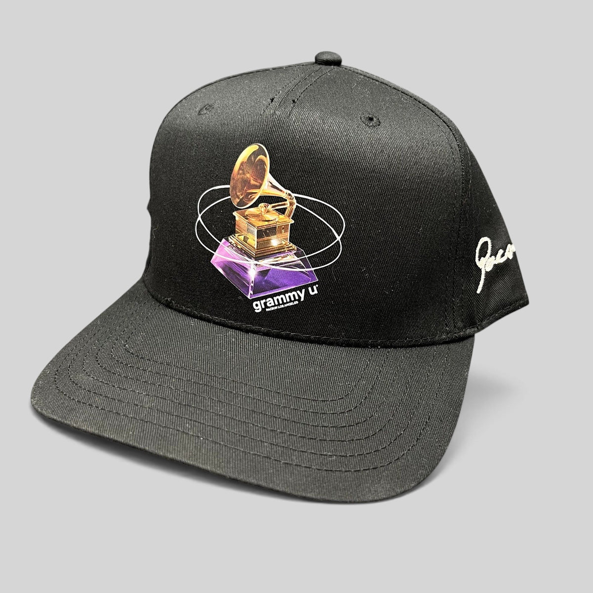 Raree Finds black Grammy U snapback hat with a gold gramophone graphic and white side embroidery on a flat bill cap.