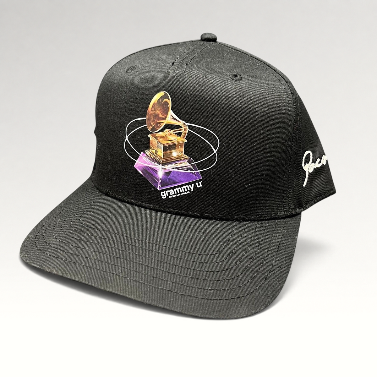 Raree Finds black Grammy U snapback hat with a gold gramophone graphic and white side embroidery on a flat bill cap.