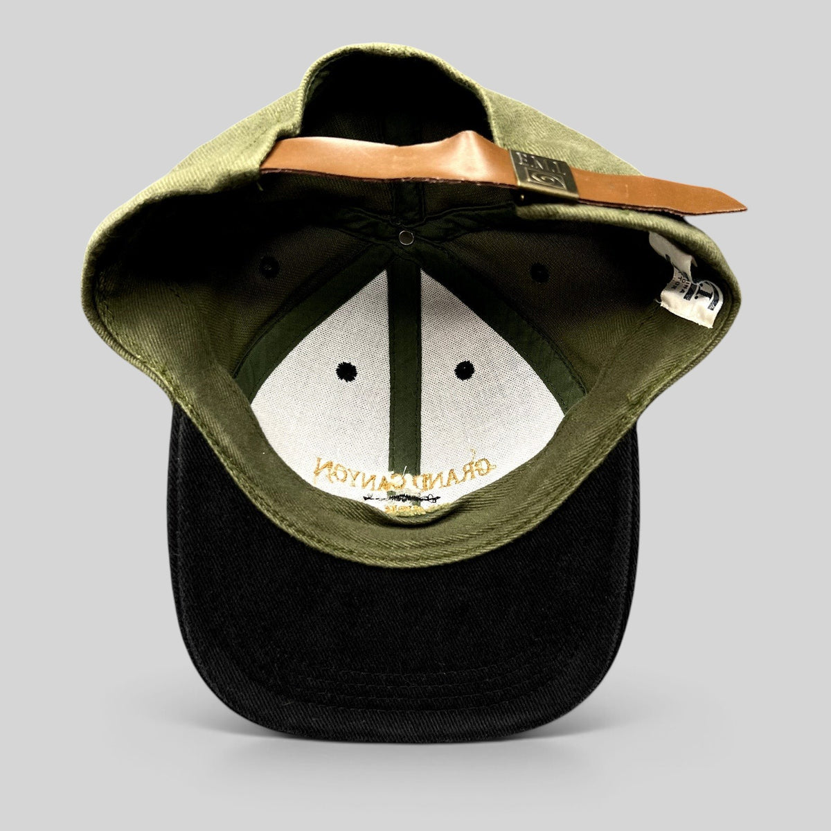 Raree Finds vintage Grand Canyon Squire Inn strapback hat with olive green cotton crown and brown leather strap