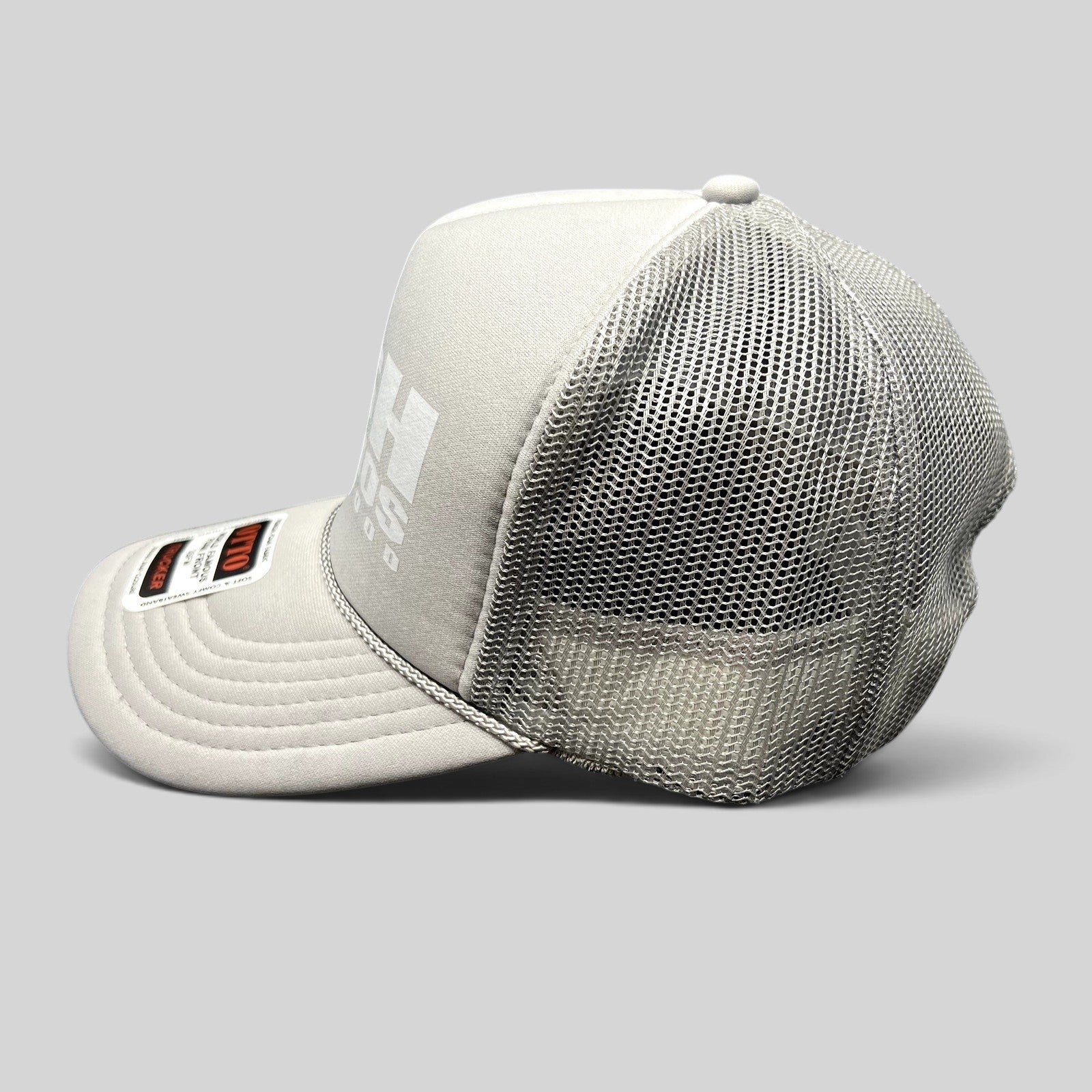 Raree Finds gray RSH Studios Hollywood trucker hat with white print, mesh back, and braided rope detail on the brim.