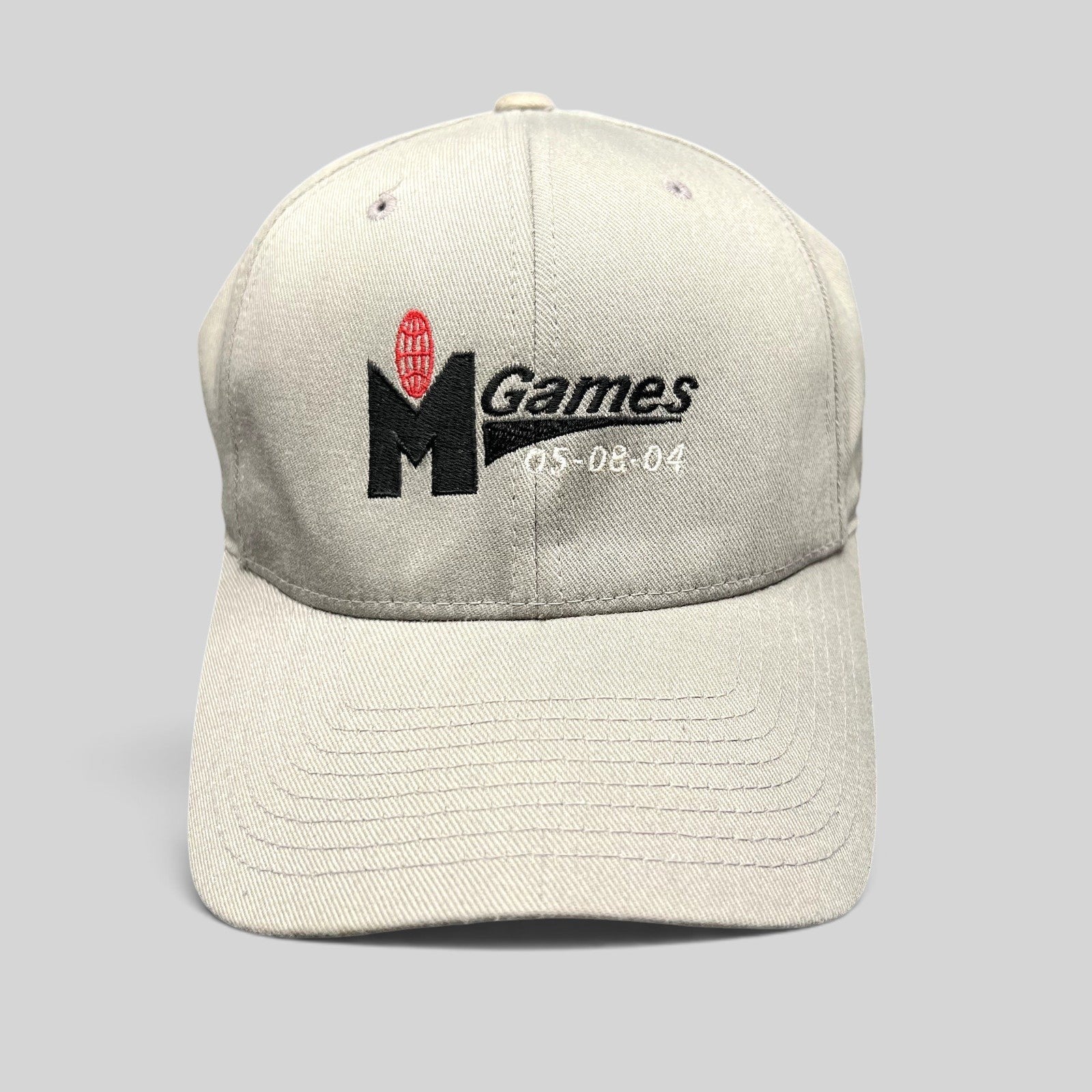 Raree Finds gray Yupoong Flexfit baseball cap with embroidered M Games logo and 2004 event dates in size S/M