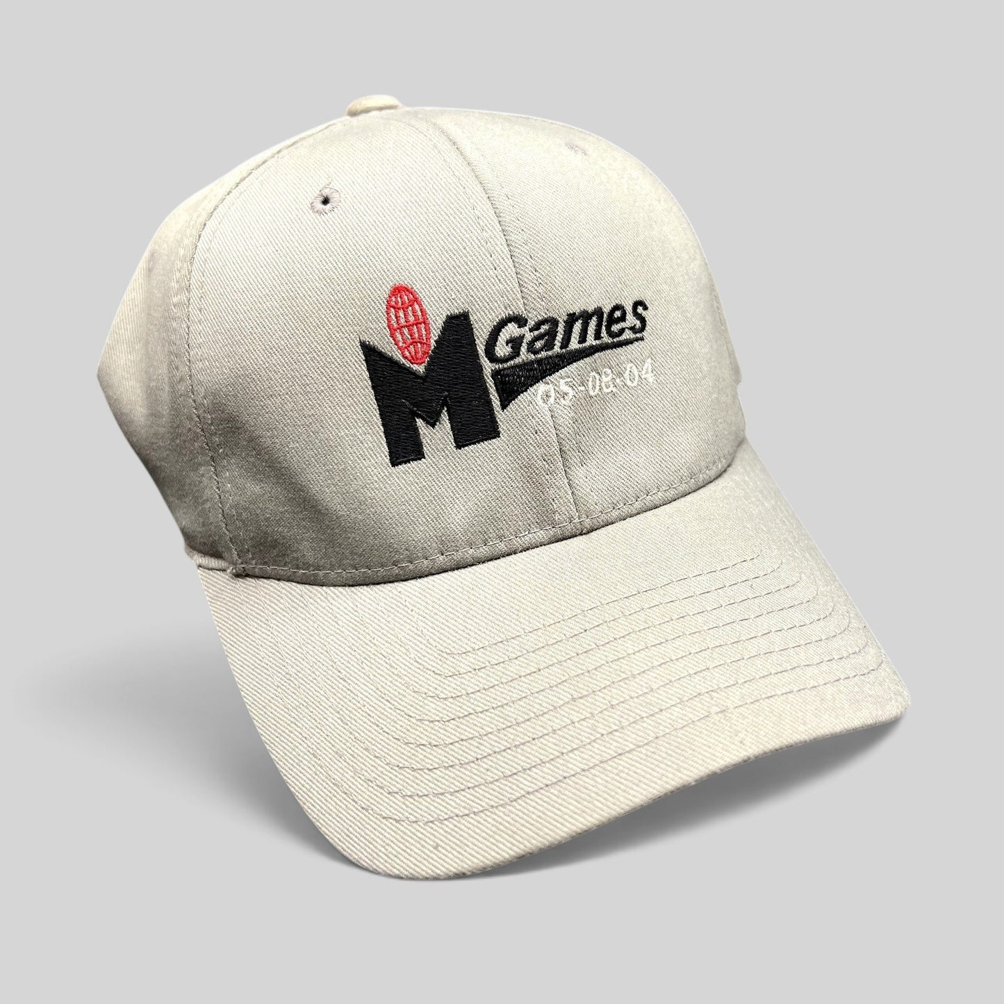 Raree Finds gray Yupoong Flexfit baseball cap with embroidered M Games 2004 logo and event dates