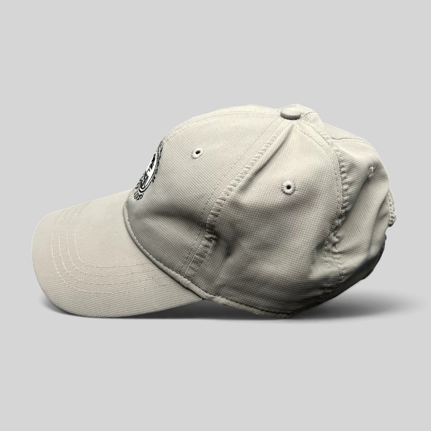 Raree Finds gray performance fabric golf cap with Pebble Beach Golf Links 1919 embroidered logo, side profile view.