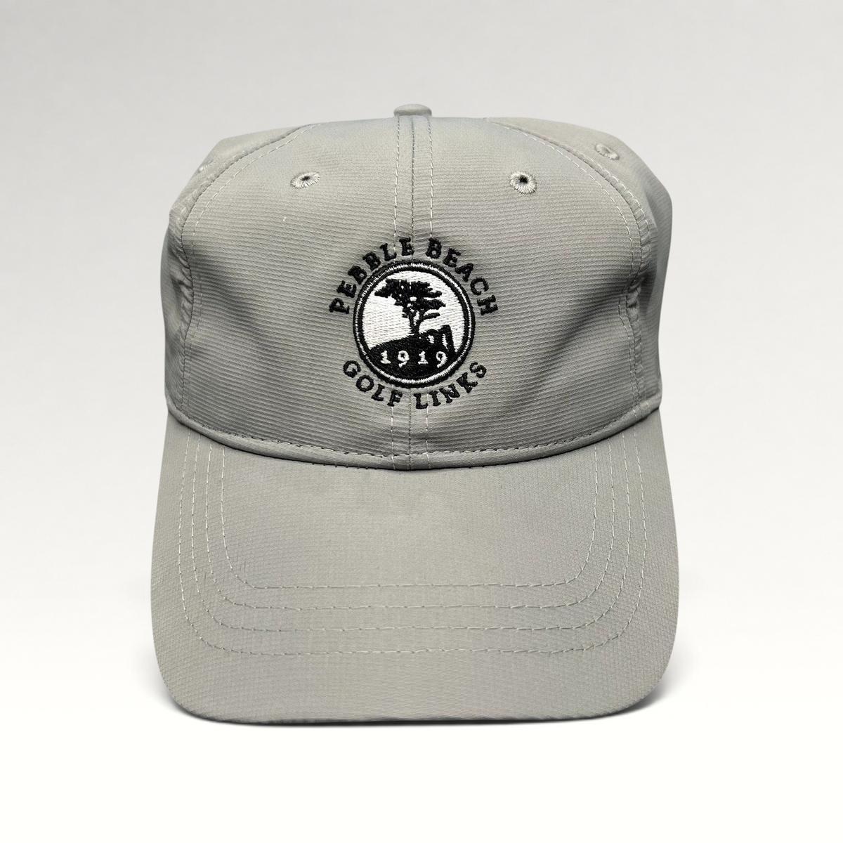 Raree Finds gray performance fabric golf cap with embroidered Pebble Beach Golf Links 1919 logo and strapback closure.