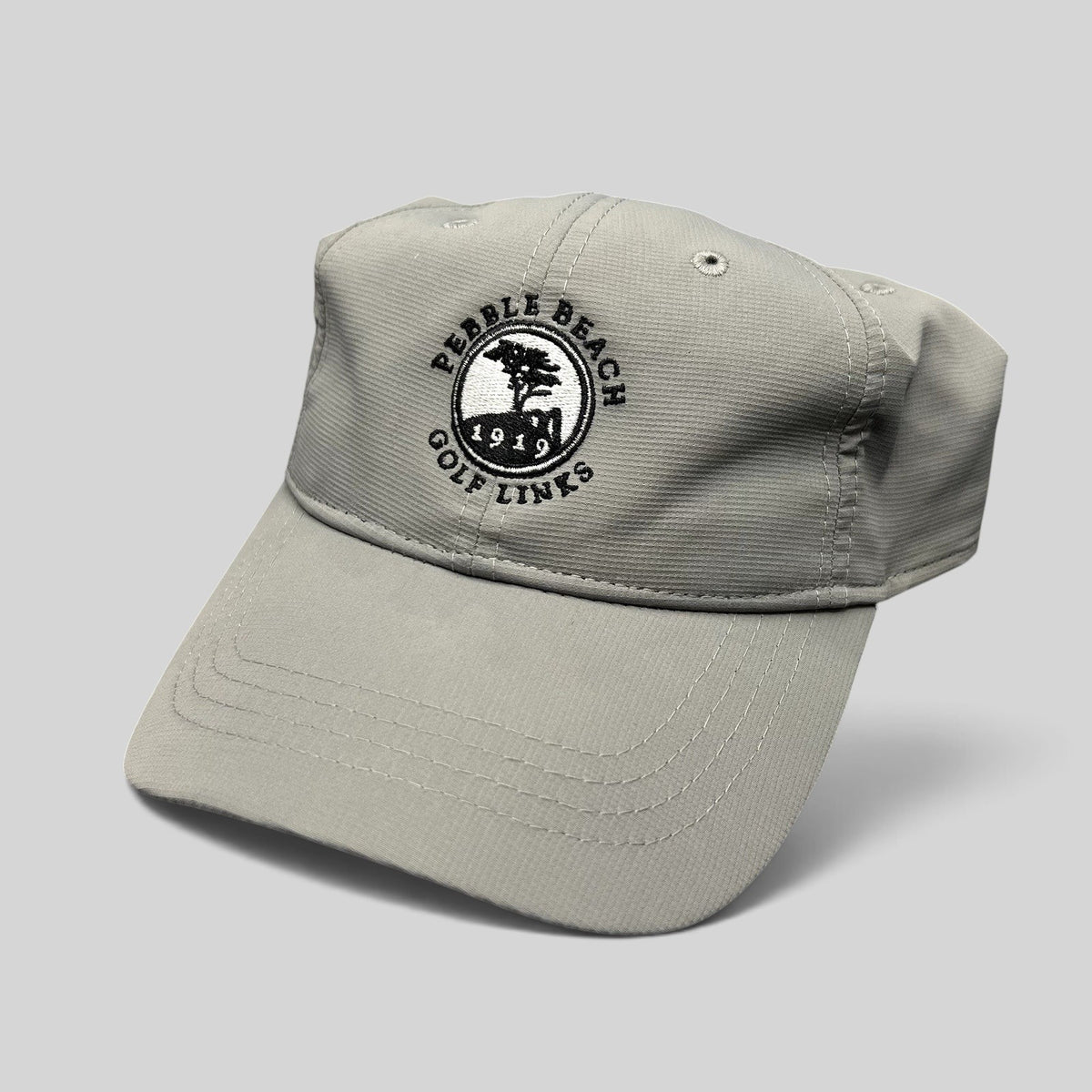 Raree Finds gray performance fabric golf cap with embroidered Pebble Beach Golf Links 1919 logo and strapback closure.