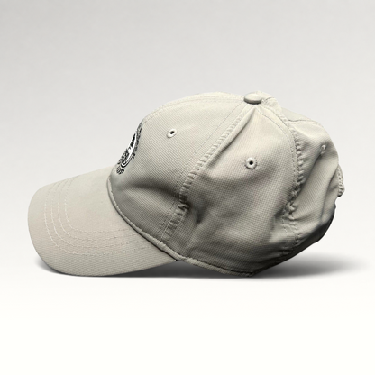Raree Finds gray performance fabric golf cap with Pebble Beach Golf Links 1919 embroidered logo, side profile view.