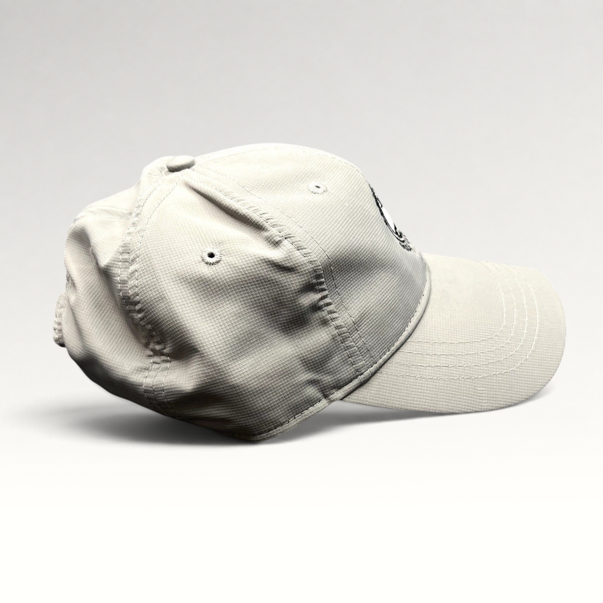 Raree Finds gray performance fabric strapback golf cap with Pebble Beach Golf Links 1919 logo, side profile view.