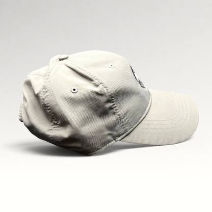 Raree Finds gray performance fabric strapback golf cap with Pebble Beach Golf Links 1919 logo, side profile view.